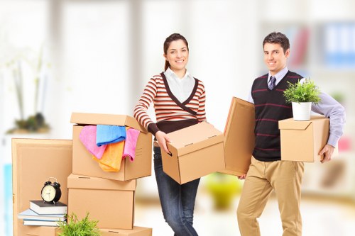 Removal crew handling household items in West London